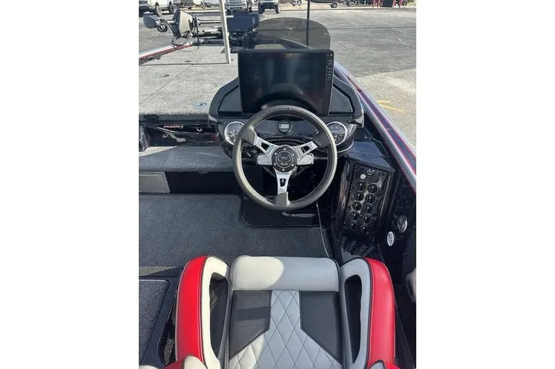 Slide: The Image of 2026 Phoenix 921 Elite X boat cockpit with steering wheel and dashboard controls. - 7