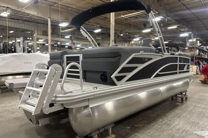 Slide: The Image of 2026 Bennington 22 MFB pontoon boat in a warehouse setting. - 5