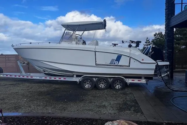 The Image of 2024 Beneteau Flyer 9 SPACEdeck boat on trailer, side view under cloudy sky. - 0