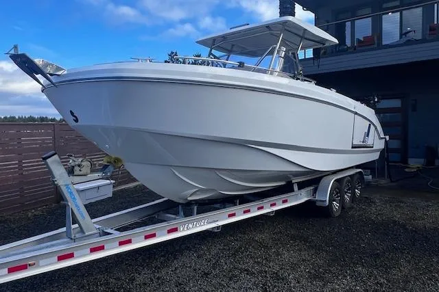 Slide: The Image of 2024 Beneteau Flyer 9 SPACEdeck boat on trailer, parked outdoors. - 1