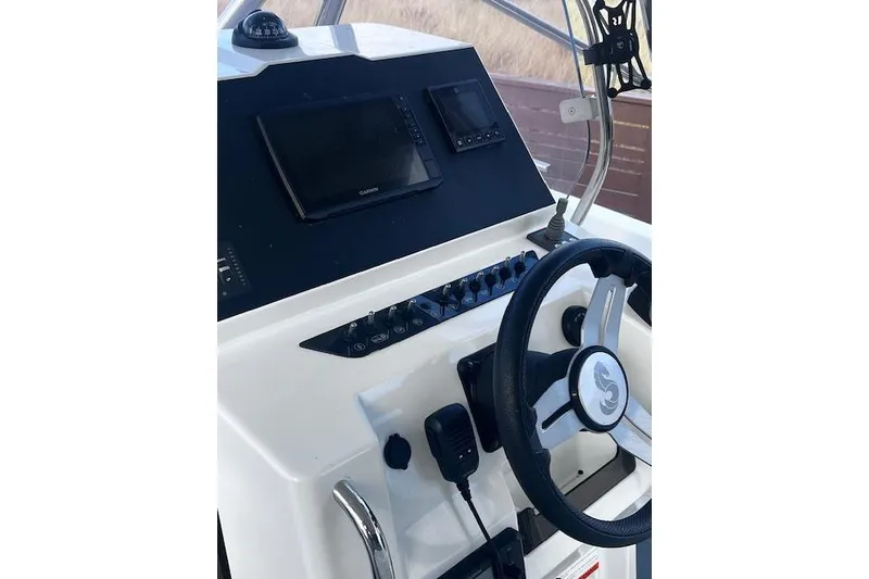 Slide: The Image of 2024 Beneteau Flyer 9 SPACEdeck helm with steering wheel and navigation controls. - 11
