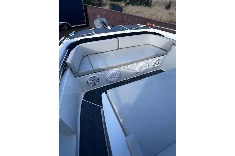 Slide: The Image of 2024 Beneteau Flyer 9 SPACEdeck boat interior with cushioned seating and speakers. - 13