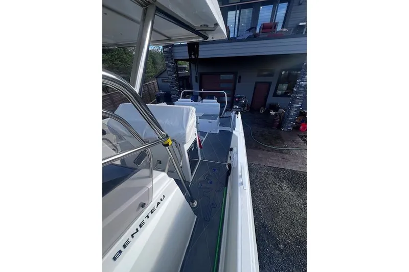 Slide: The Image of 2024 Beneteau Flyer 9 SPACEdeck boat docked near modern house. - 15