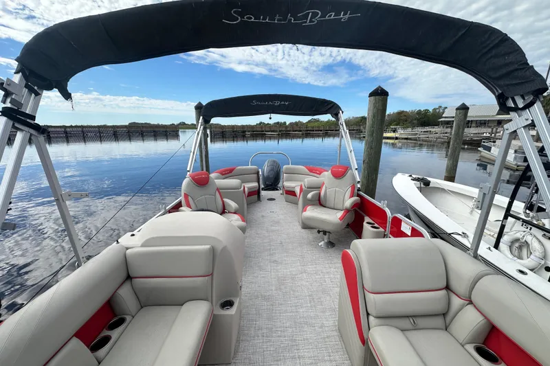 Slide: The Image of 2022 South Bay Pontoons 24 LE Series Tri Hull on calm water, featuring spacious seating. - 10