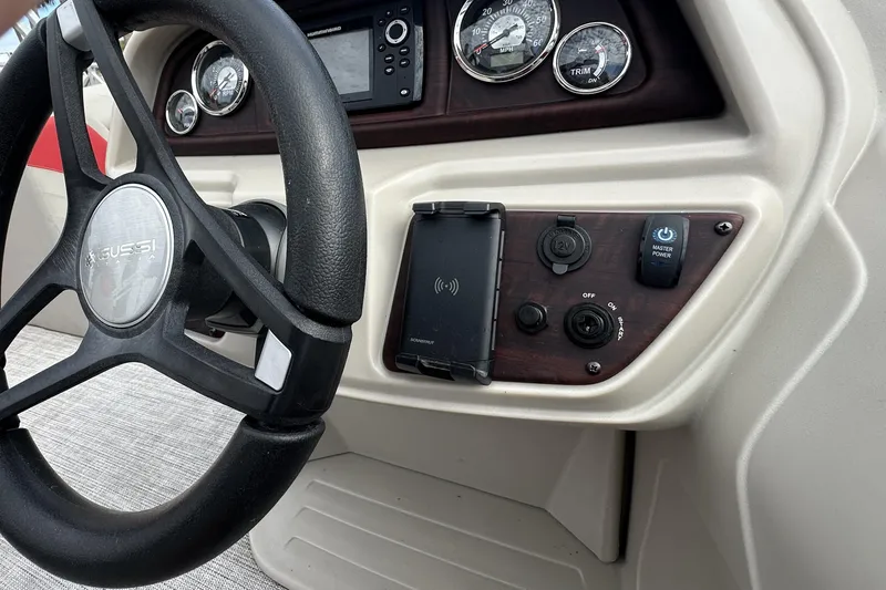 Slide: The Image of Steering console of 2022 South Bay Pontoons 24 LE Series Tri Hull with gauges and controls. - 17