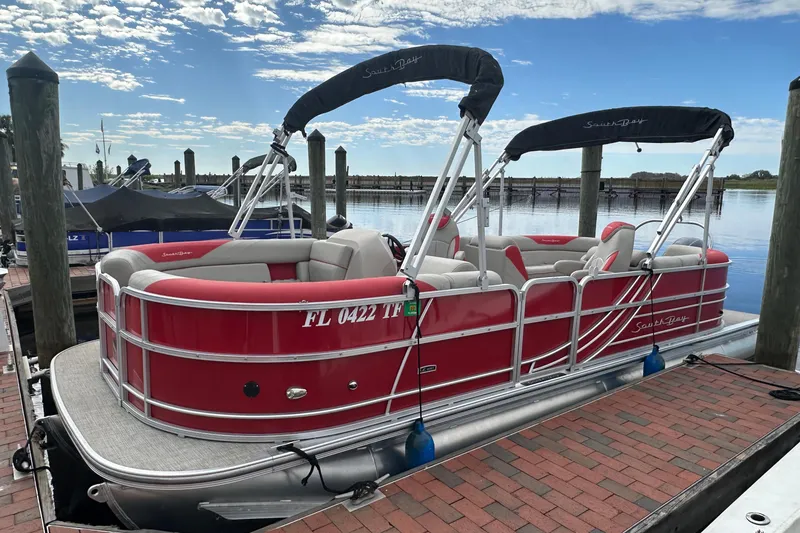Slide: The Image of 2022 South Bay Pontoons 24 LE Series Tri Hull, red, docked at marina. - 2