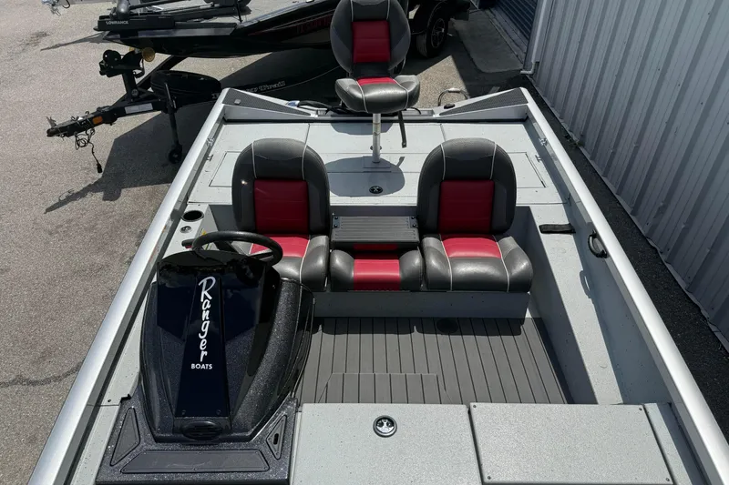 Slide: The Image of 2018 Ranger RT188 boat interior with red and black seating, steering console, and spacious deck. - 10