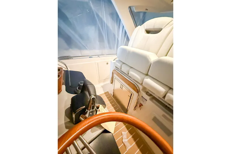 Slide: The Image of Interior of 2025 Tiara Yachts 38 LS, featuring luxurious seating and helm controls. - 18