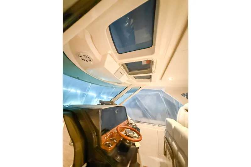 Slide: The Image of Interior view of 2025 Tiara Yachts 38 LS helm with modern controls and skylights. - 20