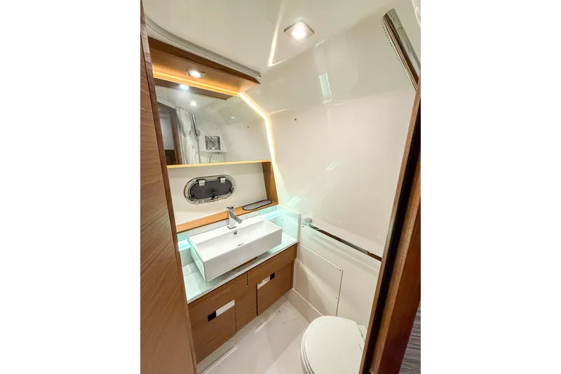 Slide: The Image of Luxurious bathroom interior of 2025 Tiara Yachts 38 LS, featuring modern sink and lighting. - 21
