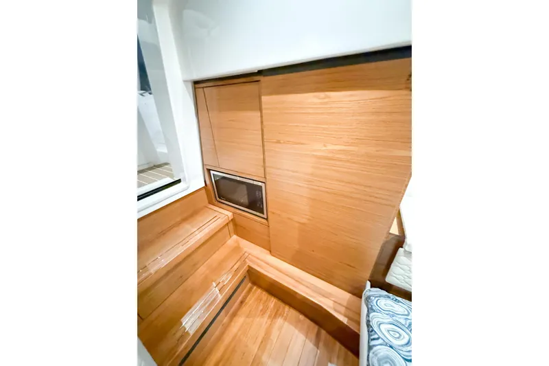 Slide: The Image of 2025 Tiara Yachts 38 LS interior with wood paneling and built-in microwave. - 25