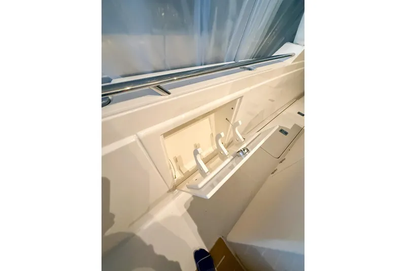 Slide: The Image of 2025 Tiara Yachts 38 LS interior detail with storage compartment and hooks. - 27