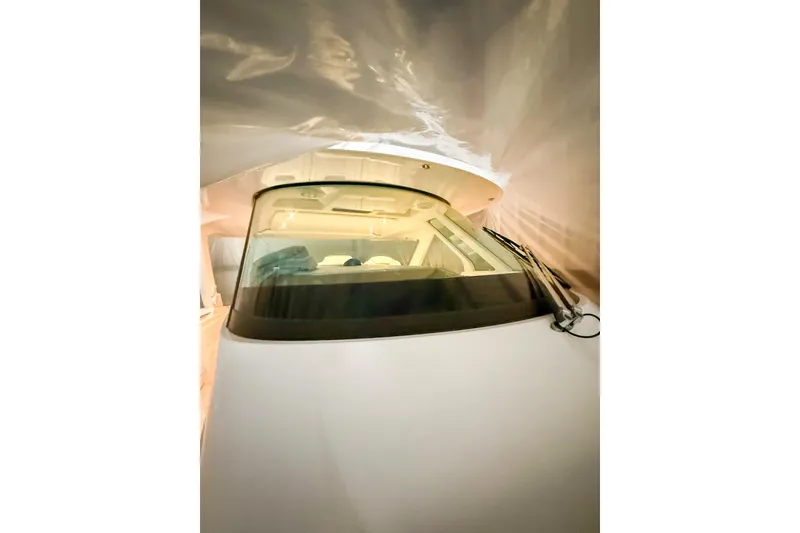 Slide: The Image of 2025 Tiara Yachts 38 LS boat interior view with windshield and cabin details. - 30