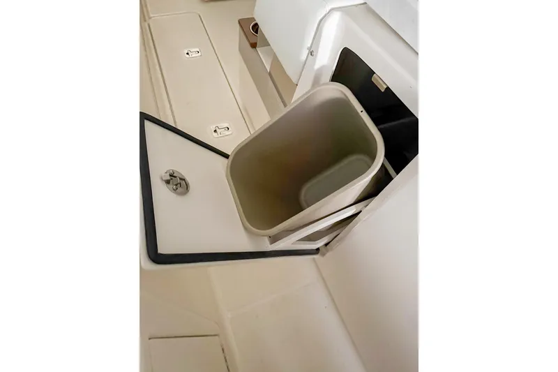 Slide: The Image of Built-in storage compartment on 2025 Tiara Yachts 38 LS, featuring a removable bin. - 32