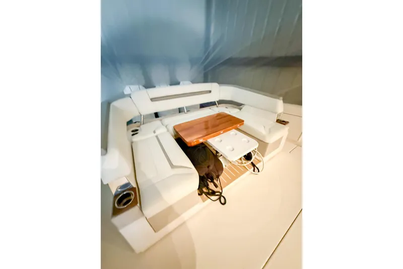 Slide: The Image of 2025 Tiara Yachts 38 LS interior with white seating and wooden table. - 6