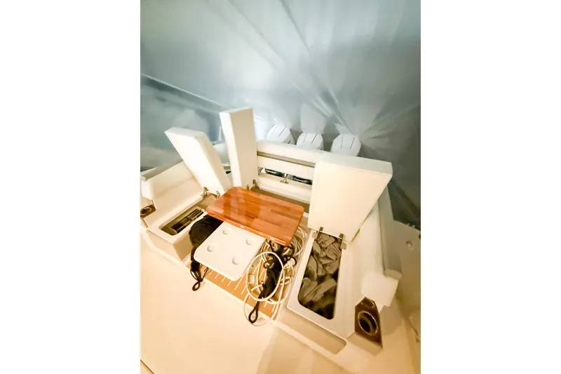 Slide: The Image of 2025 Tiara Yachts 38 LS interior with storage compartments and wooden table. - 7