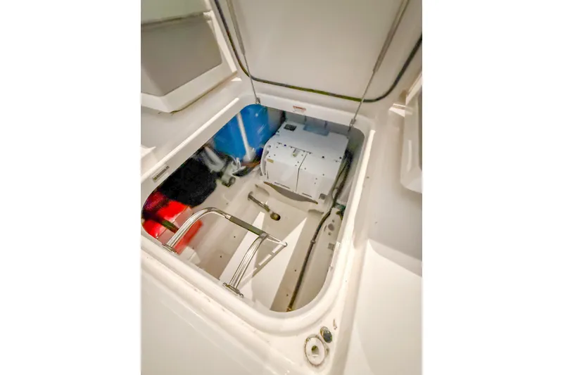 Slide: The Image of 2025 Tiara Yachts 38 LS storage compartment with equipment and wiring. - 9