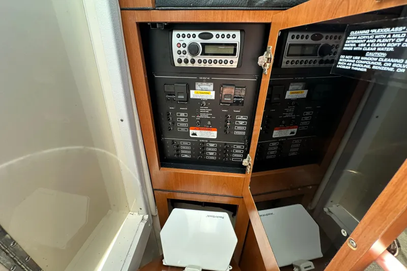 Slide: The Image of Electrical panel inside a 2006 Wellcraft 290 Coastal boat, featuring control switches and a stereo system. - 14