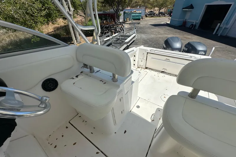 Slide: The Image of 2006 Wellcraft 290 Coastal boat interior with white seating and dual Yamaha engines. - 15