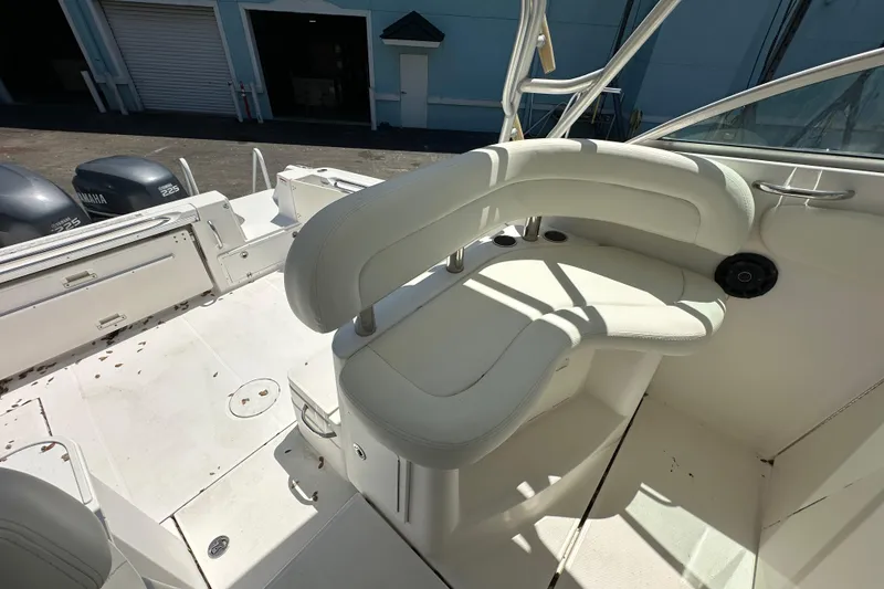 Slide: The Image of 2006 Wellcraft 290 Coastal boat interior with white seating and Yamaha engines. - 16