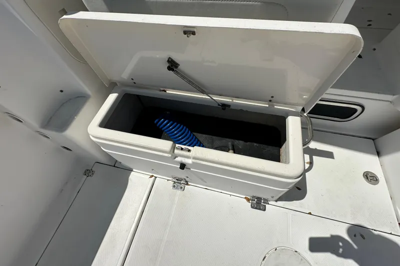 Slide: The Image of Open storage compartment on 2006 Wellcraft 290 Coastal boat deck. - 19