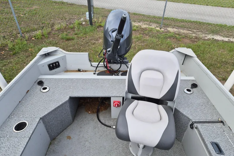 Slide: The Image of 2018 Smoker Craft Angler 16 SC boat interior with seating and motor. - 12