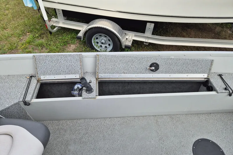 Slide: The Image of 2018 Smoker Craft Angler 16 SC boat interior with open storage compartments. - 5