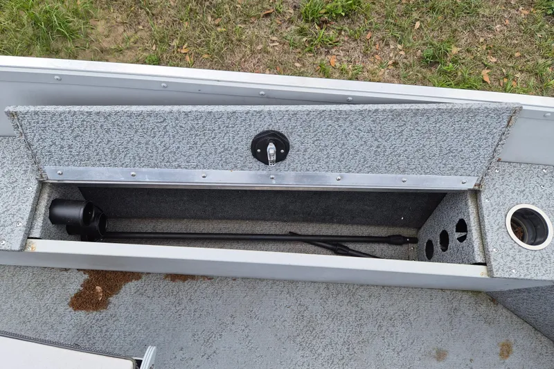 Slide: The Image of 2018 Smoker Craft Angler 16 SC boat storage compartment with rod holder and cup holder. - 8