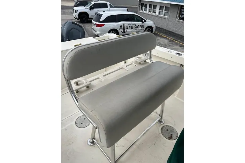Slide: The Image of Gray cushioned bench seat on 2001 Pursuit 2670 Cuddy Console boat deck. - 12