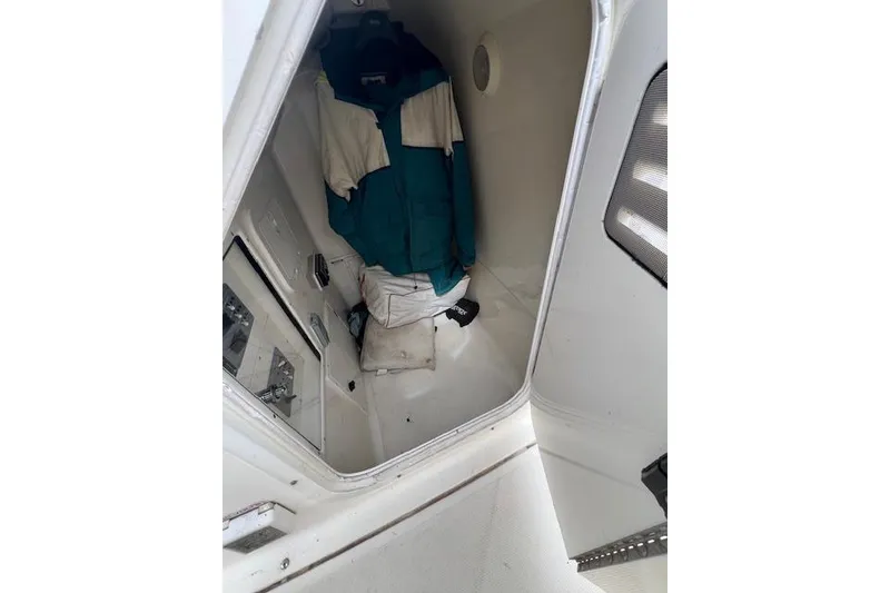 Slide: The Image of Interior of 2001 Pursuit 2670 Cuddy Console with clothing and storage space. - 5