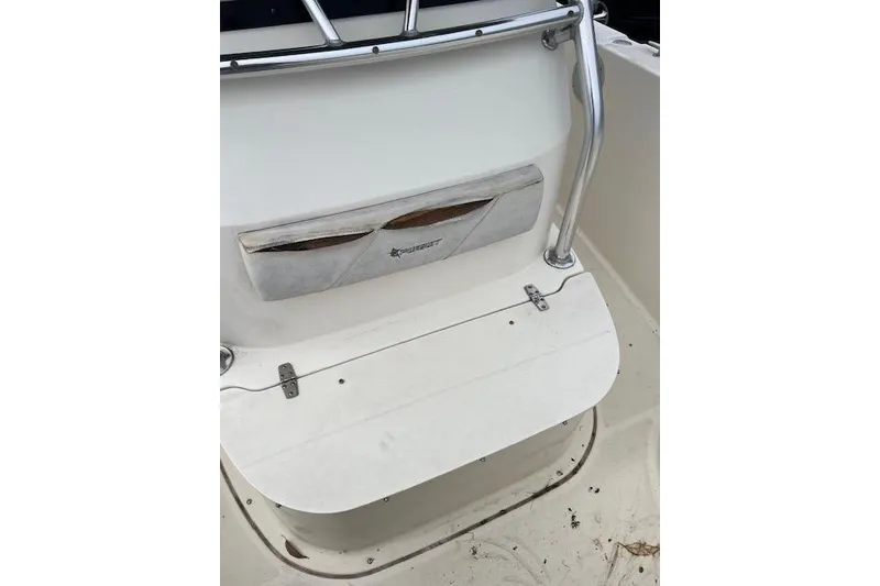 Slide: The Image of 2001 Pursuit 2670 Cuddy Console boat interior with seating and railing. - 7