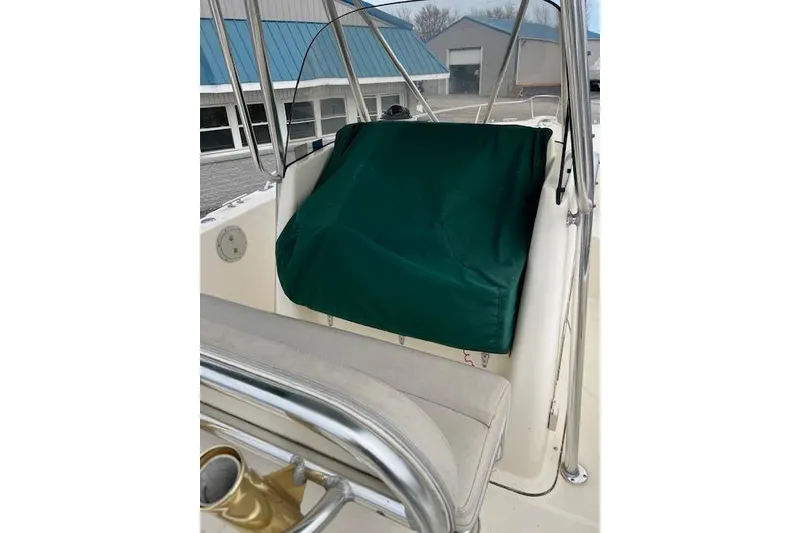 Slide: The Image of 2001 Pursuit 2670 Cuddy Console boat interior with green cover and seating. - 8