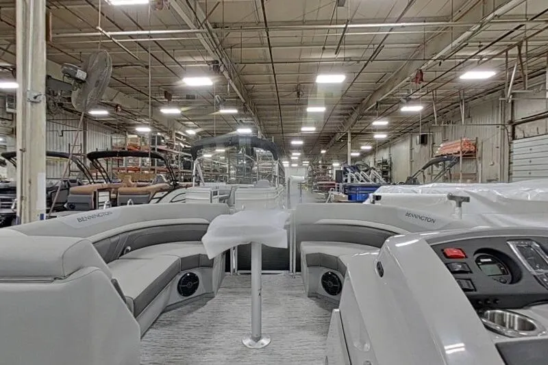 Slide: The Image of 2026 Bennington 22SXSR pontoon boat interior in a factory setting. - 15