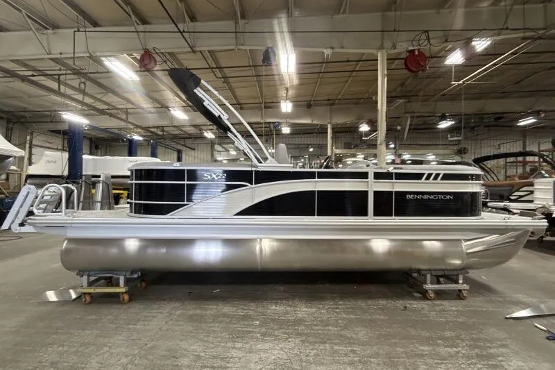 Slide: The Image of 2026 Bennington 22SXSR pontoon boat in a warehouse setting. - 4