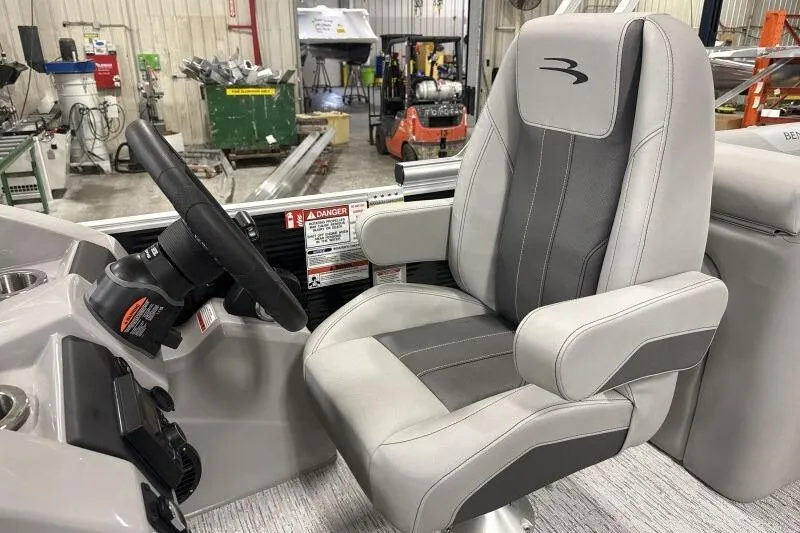 Slide: The Image of Captain's chair and steering wheel of 2026 Bennington 22SXSR boat in a workshop setting. - 5