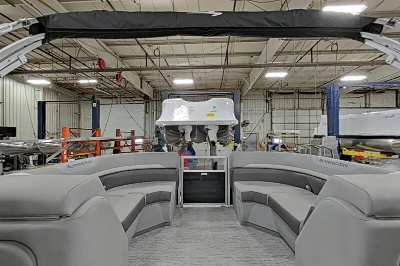 Slide: The Image of 2026 Bennington 22SXSR pontoon boat interior in a warehouse setting. - 9