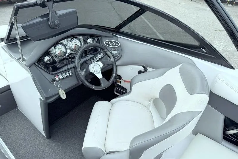 Slide: The Image of Interior view of 2014 Tigé R20 boat cockpit with steering wheel and gauges. - 11