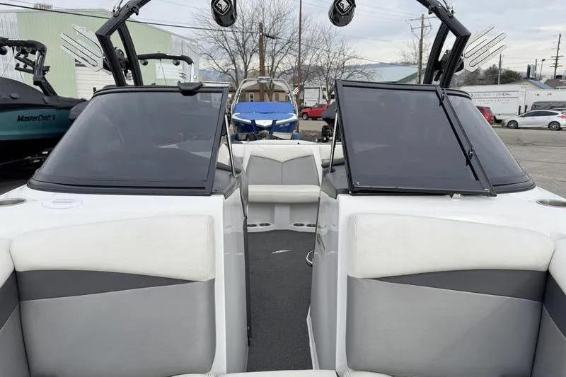 Slide: The Image of 2014 Tigé R20 boat interior with gray and white seating, open bow area. - 14