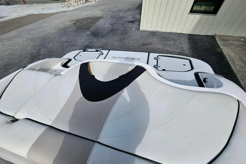 Slide: The Image of Rear view of a 2011 Bryant 210 boat with sleek white seating. - 13