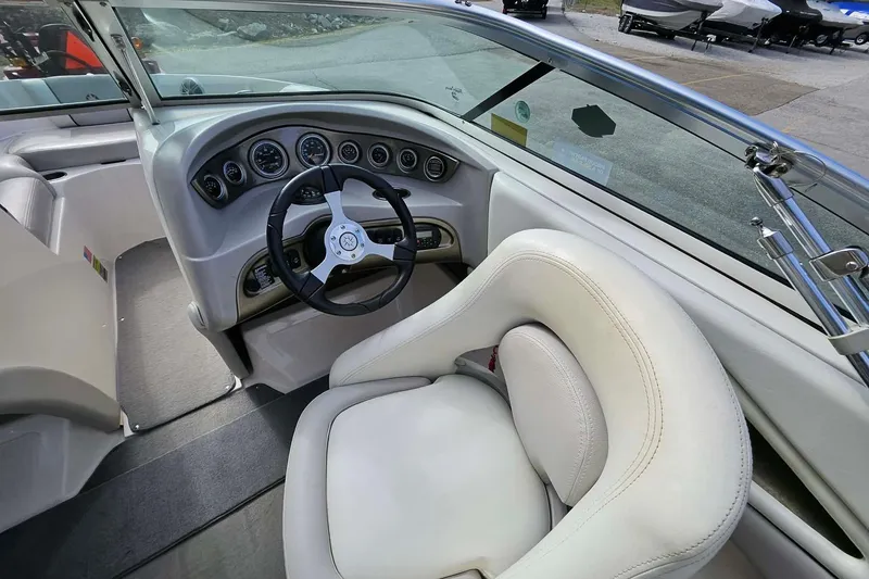 Slide: The Image of Interior of a 2011 Bryant 210 boat featuring steering wheel and dashboard controls. - 14