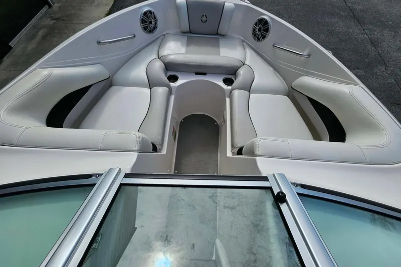Slide: The Image of Interior of a 2011 Bryant 210 boat with white seating and cup holders. - 5