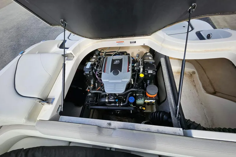 Slide: The Image of Open engine compartment of a 2011 Bryant 210 boat, showcasing the engine details. - 9
