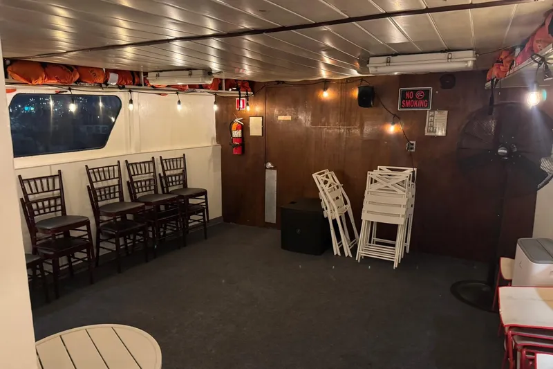 Slide: The Image of Interior of 1985 Custom Commercial Steel 100 boat with chairs and "No Smoking" sign. - 9