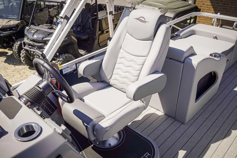Slide: The Image of 2025 SunCatcher Fusion 324SS boat interior with luxurious captain's chair and steering console. - 19