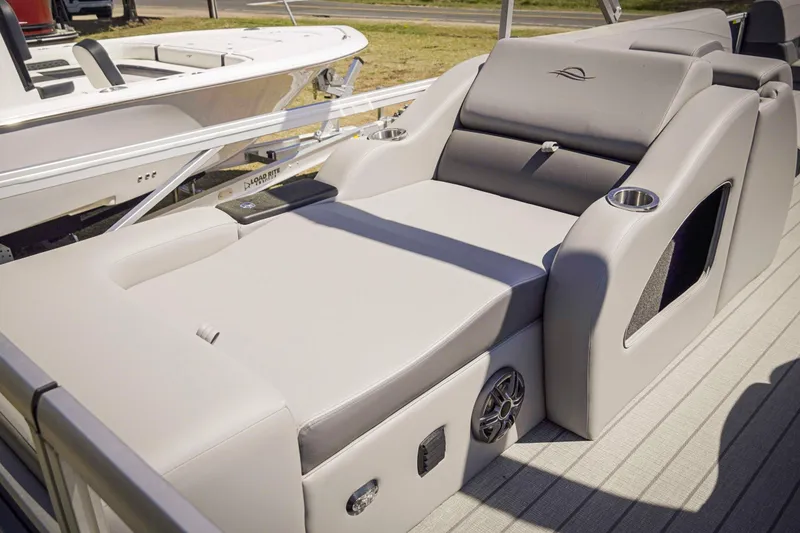 Slide: The Image of Luxurious seating on 2025 SunCatcher Fusion 324SS pontoon boat, featuring cup holders and speakers. - 23