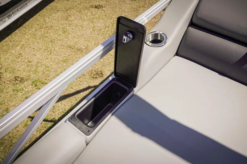 Slide: The Image of 2025 SunCatcher Fusion 324SS boat seat with storage compartment and cup holder. - 24