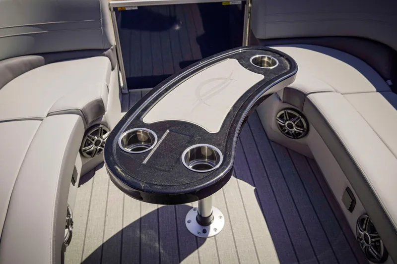 Slide: The Image of Luxurious seating area on 2025 SunCatcher Fusion 324SS boat with stylish table and cup holders. - 26