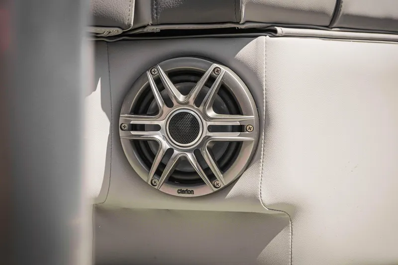 Slide: The Image of Speaker on SunCatcher Fusion 324SS boat, 2025 model, with sleek metallic design. - 27