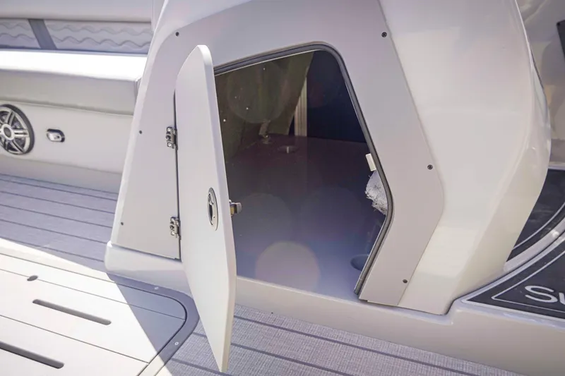 Slide: The Image of Open storage compartment on 2025 SunCatcher Fusion 324SS boat deck. - 29