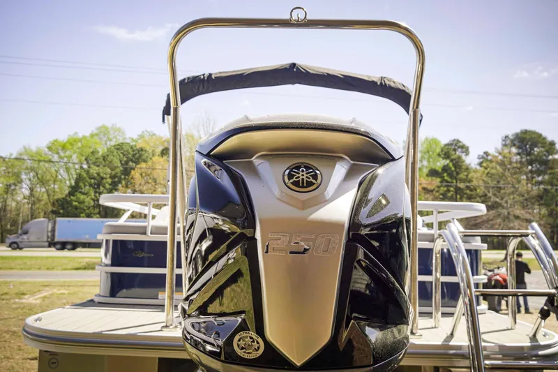 Slide: The Image of 2025 SunCatcher Fusion 324SS boat with powerful 250 engine, parked outdoors. - 5